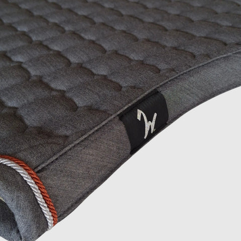 Gigolo saddle pad in anthracite melange with light grey/rust colored piping
